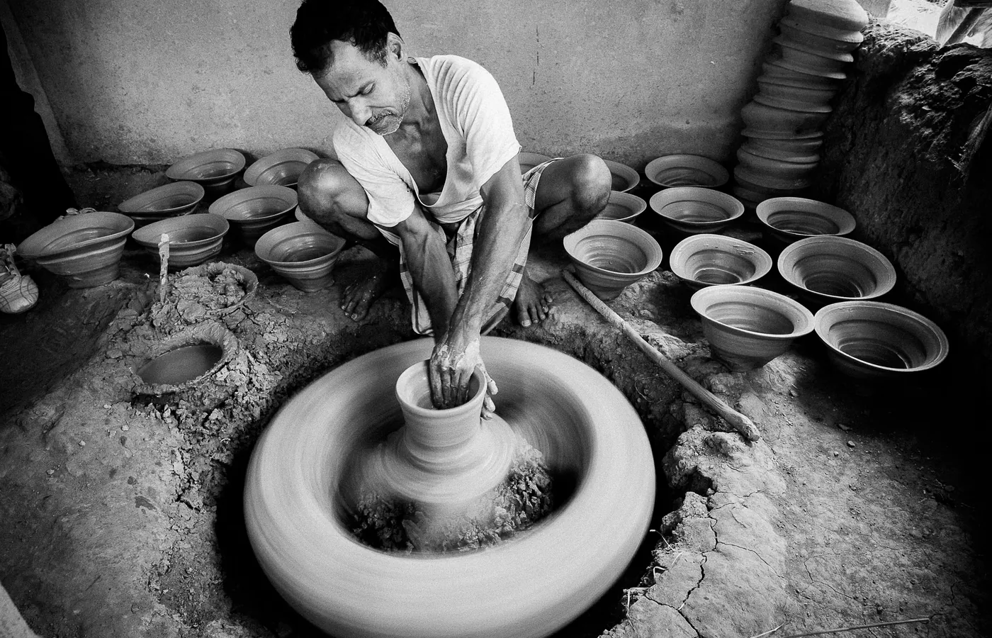 A potter at a hand turned wheel